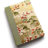 The Sho Chiku Bai keepsake card showcases an elegant Japanese-inspired design featuring pine, bamboo, and plum blossoms—symbols of resilience, growth, and renewal. The intricate gold-accented cover is paired with a sage green book cloth spine, creating a timeless piece perfect for commemorating special occasions, heartfelt messages, and lasting memories.