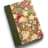 The Ume No Hana keepsake card features a stunning Japanese-inspired plum blossom pattern in red, beige, and purple hues. Handcrafted with a rich green book cloth spine, this elegant card is perfect for heartfelt messages, special occasions, and treasured memories.