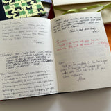 An open handmade keepsake card filled with handwritten farewell messages from colleagues and friends. The high-quality, textured pages provide a heartfelt space for meaningful notes, making this a perfect personalized gift for special occasions like retirements, departures, or milestone celebrations. Surrounding keepsake cards showcase various available designs.