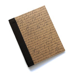 The Storyteller's Bookmaking Kit features a rustic, vintage-inspired cover adorned with elegant handwritten script on textured brown paper. Paired with a classic black book cloth spine, this DIY kit provides everything needed to craft a personalized journal, perfect for writers, artists, and book lovers who want to create a meaningful keepsake.