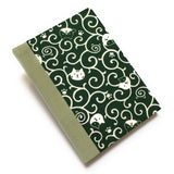 This handcrafted journal features a deep green fabric cover adorned with playful cat illustrations and swirling patterns. Bound with a sage green bookbinding cloth, it is perfect for journaling, sketching, or note-taking, making it a great gift for cat lovers.