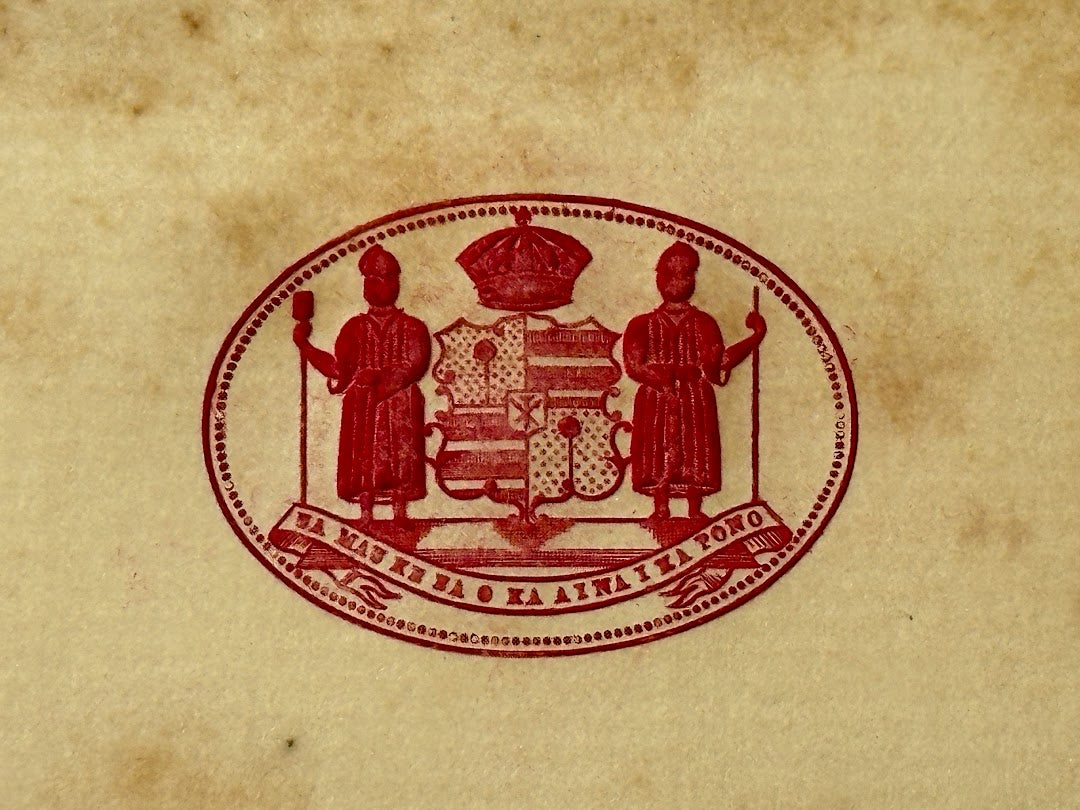 A red-ink seal of the Hawaiian Kingdom's Coat of Arms from a historic scrapbook restoration project, preserving Hawaii’s royal history and cultural heritage.