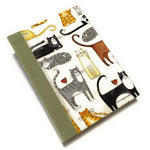 This handmade journal features a delightful fabric cover adorned with playful illustrated cats in various poses, making it a perfect notebook for cat lovers. Bound with a durable sage green spine and filled with high-quality blank pages, it's an ideal choice for journaling, sketching, or note-taking with a touch of feline charm.