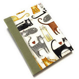 This handmade journal features a delightful fabric cover adorned with playful illustrated cats in various poses, making it a perfect notebook for cat lovers. Bound with a durable sage green spine and filled with high-quality blank pages, it's an ideal choice for journaling, sketching, or note-taking with a touch of feline charm.