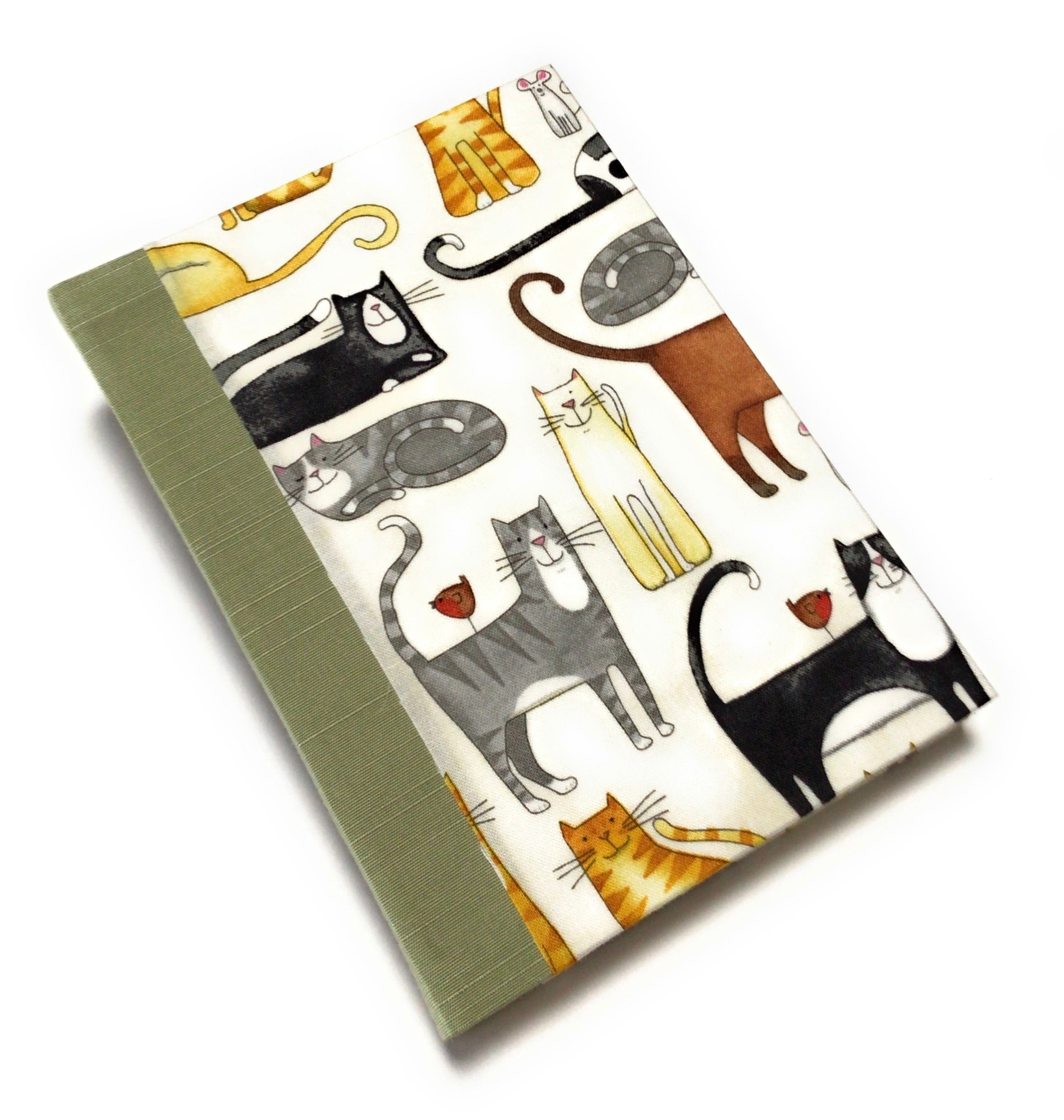 This handmade journal features a delightful fabric cover adorned with playful illustrated cats in various poses, making it a perfect notebook for cat lovers. Bound with a durable sage green spine and filled with high-quality blank pages, it's an ideal choice for journaling, sketching, or note-taking with a touch of feline charm.