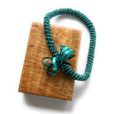 A beautifully handcrafted Mango Wood Coptic Journal paired with a Hawaiian ribbon lei in teal. This elegant wooden notebook features an exposed spine for flexibility and durability, perfect for journaling, sketching, or gift-giving. The ribbon lei adds a touch of cultural significance, symbolizing love, friendship, and celebration. 