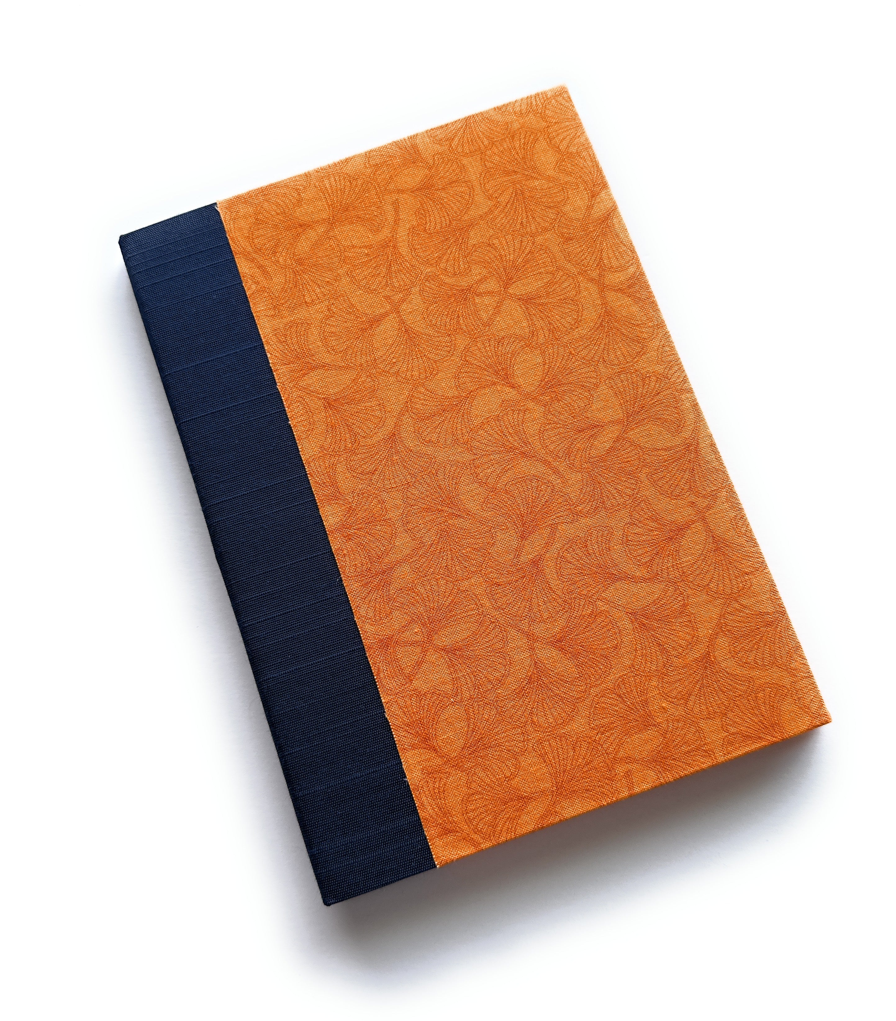 The Aki No Ginnan keepsake card features a warm autumn-inspired design with a golden-orange ginkgo leaf pattern, symbolizing longevity and resilience. The deep navy blue book cloth spine provides a striking contrast, creating an elegant and timeless piece. Perfect for heartfelt messages, special celebrations, or treasured memories.