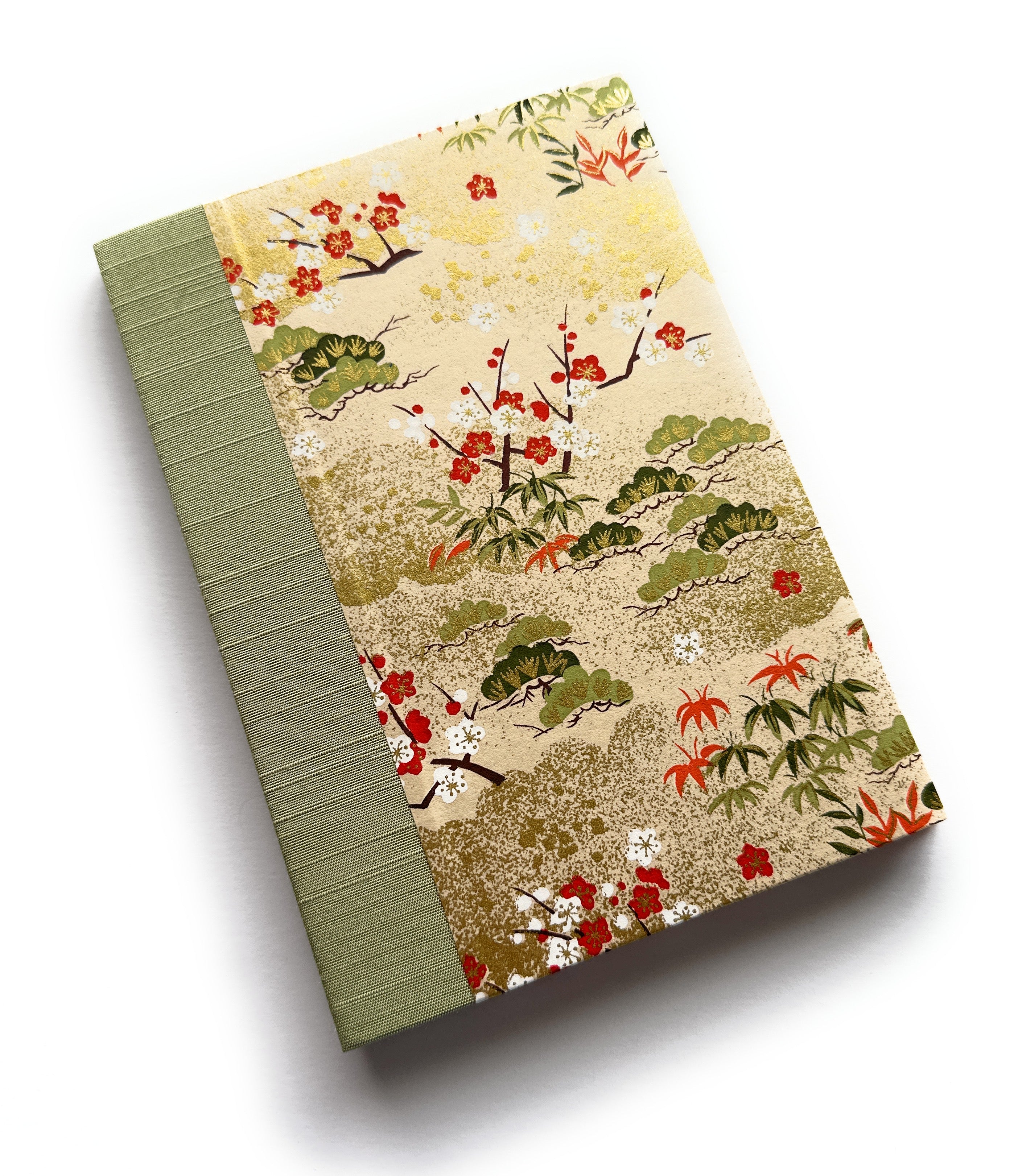 The Sho Chiku Bai keepsake card showcases an elegant Japanese-inspired design featuring pine, bamboo, and plum blossoms—symbols of resilience, growth, and renewal. The intricate gold-accented cover is paired with a sage green book cloth spine, creating a timeless piece perfect for commemorating special occasions, heartfelt messages, and lasting memories.
