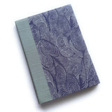 The Uzumaki keepsake card features a mesmerizing deep indigo pattern of swirling waves, inspired by the natural movement of water. Paired with a soft sage green book cloth spine, this handcrafted card is both elegant and serene, making it the perfect choice for preserving heartfelt messages and special memories.