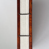 Close-up view of the exposed spine of a handcrafted Koa wood Coptic journal, showcasing the intricate hand-stitched binding with dark thread. The open-spine design allows for a flexible and durable structure, making it ideal for writing or sketching.