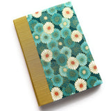 A handcrafted keepsake card featuring a vibrant chrysanthemum (kiku) floral design in shades of teal, cream, and gold. This Japanese-inspired fabric-covered booklet is perfect for heartfelt messages, well-wishes, or as a unique gift.