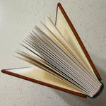 Top view of a Leather Quarter Binding standing on a speckled surface