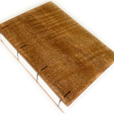 The Mango Wood Coptic Journal features a beautifully handcrafted wooden cover made from rich, warm-toned mango wood, showcasing natural grain patterns. The exposed spine  allows the journal to lay flat when open, making it an excellent choice for writers, artists, and journal enthusiasts seeking a durable, one-of-a-kind notebook.