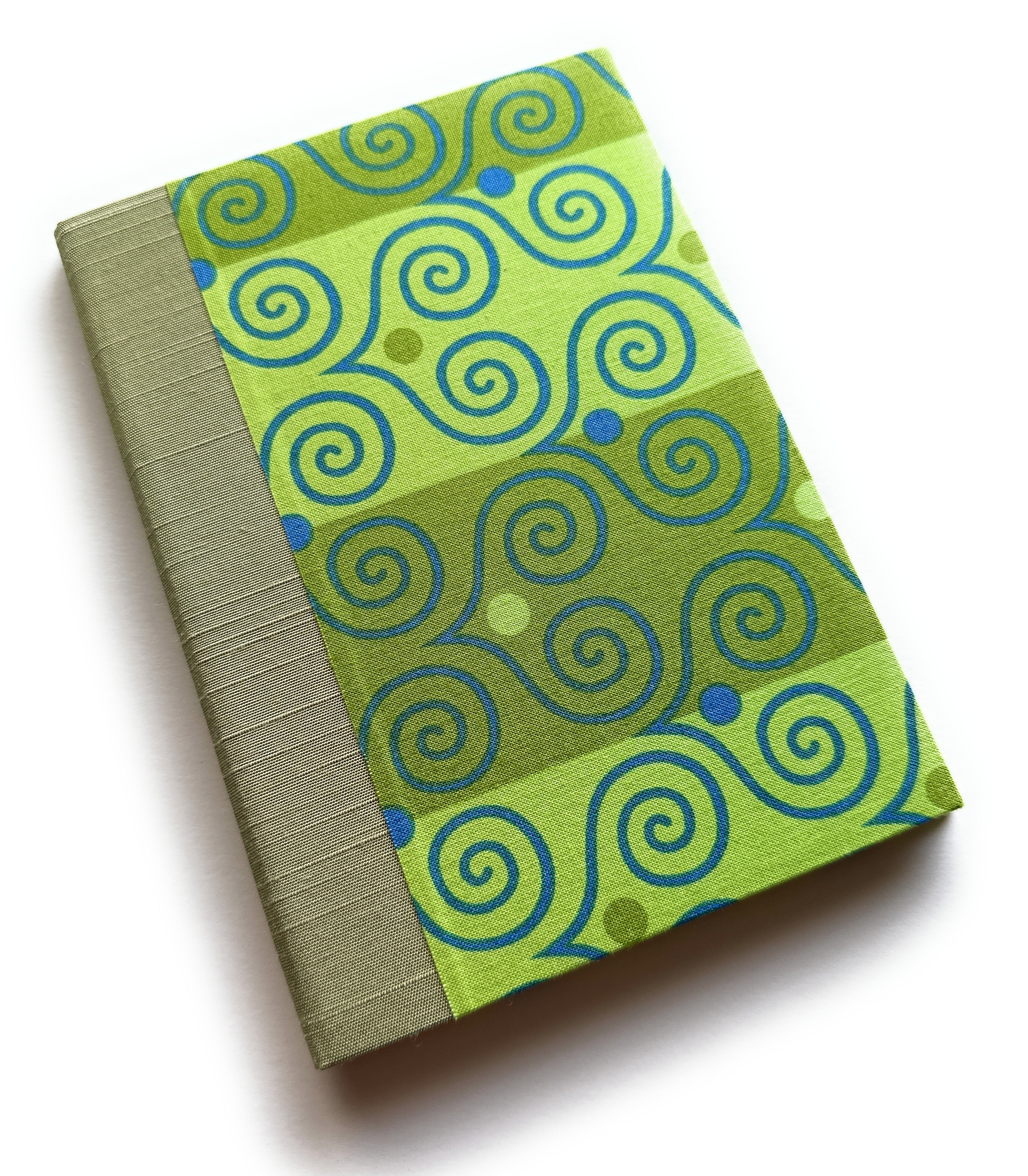 A handmade card with bright green fabric printed with playful blue and olive swirls, paired with a textured sage-green spine -- part of a unique keepsake card collection