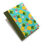 This Aloha Journal features a vibrant pineapple and floral fabric cover, bringing a touch of the tropics to your writing experience. Handcrafted with a durable bookbinding cloth spine, this hardcover notebook is designed to last. Inside, premium blank pages offer the perfect space for journaling, sketching, or note-taking. Ideal for those who love Hawaiian-inspired stationery or unique handmade journals.