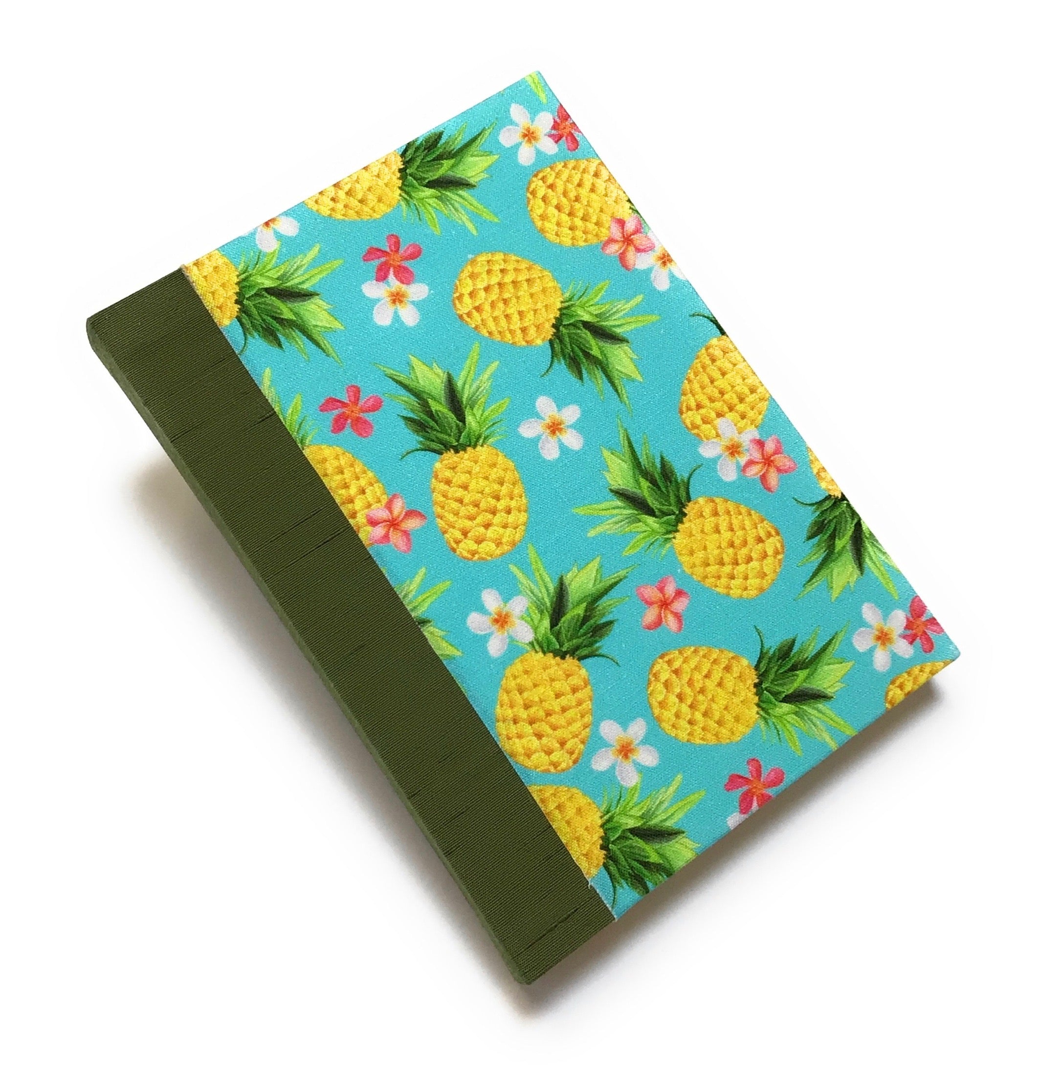This Aloha Journal features a vibrant pineapple and floral fabric cover, bringing a touch of the tropics to your writing experience. Handcrafted with a durable bookbinding cloth spine, this hardcover notebook is designed to last. Inside, premium blank pages offer the perfect space for journaling, sketching, or note-taking. Ideal for those who love Hawaiian-inspired stationery or unique handmade journals.
