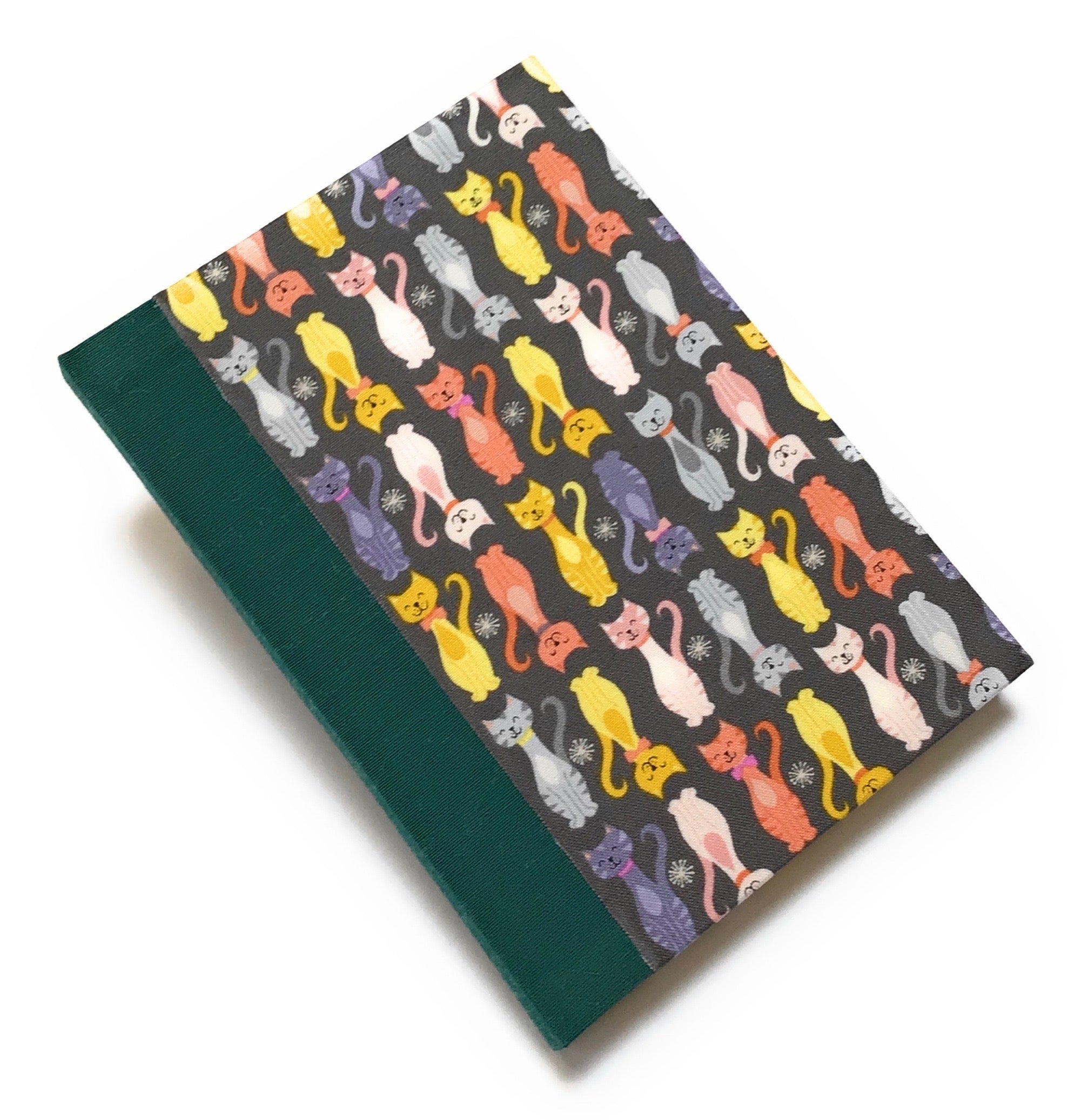 This handmade journal features a charming cat-themed fabric cover with a playful pattern of colorful kittens on a dark background. Designed with high-quality craftsmanship, it’s the perfect notebook for cat lovers, writers, and artists who enjoy capturing their thoughts in a unique and stylish way.