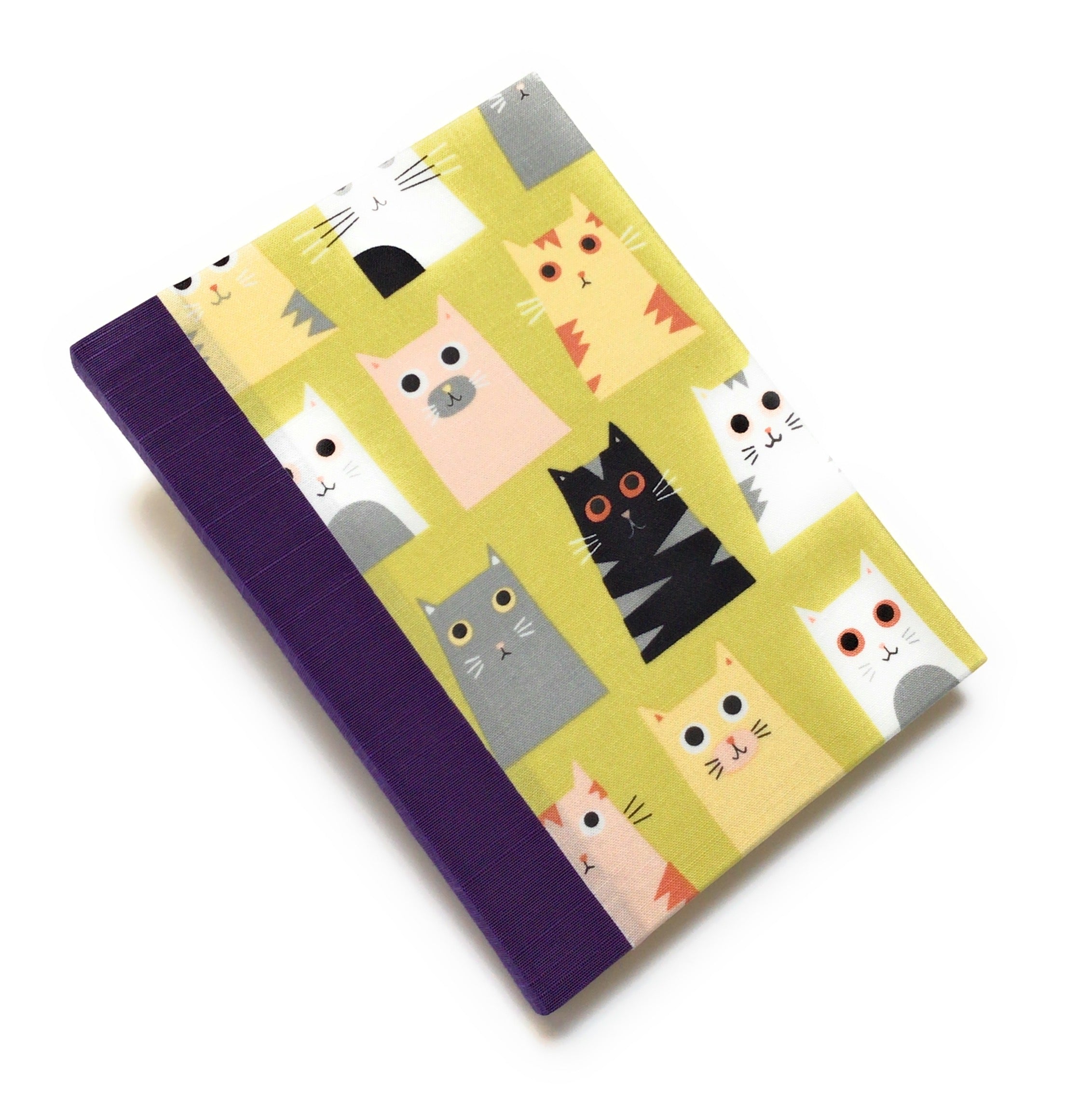 This handmade cat-themed journal features a whimsical fabric cover with a variety of charming cats on a vibrant yellow background. The purple bookbinding cloth spine adds strength, while the blank interior pages provide ample space for journaling, sketching, or note-taking. Perfect for cat lovers, stationery enthusiasts, and those who appreciate unique handmade notebooks, this playful feline journal makes a great gift or personal keepsake.
