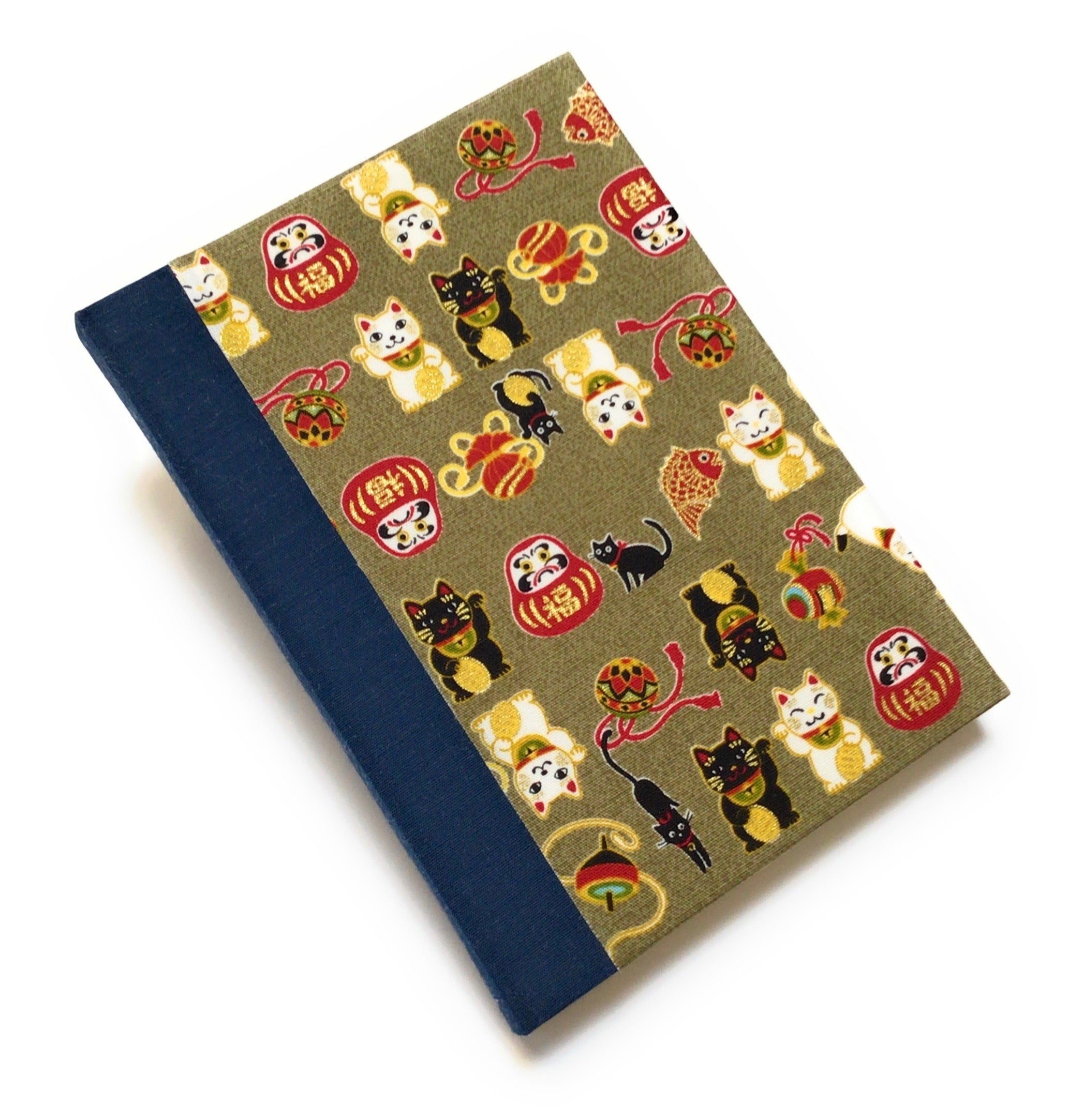 This beautifully handcrafted journal features a traditional Japanese Maneki Neko (lucky cat) and Daruma doll pattern on a high-quality fabric cover, symbolizing prosperity and good fortune. Designed for cat lovers, writers, and creatives, this unique notebook is perfect for journaling, sketching, or note-taking, making it a meaningful and stylish gift.