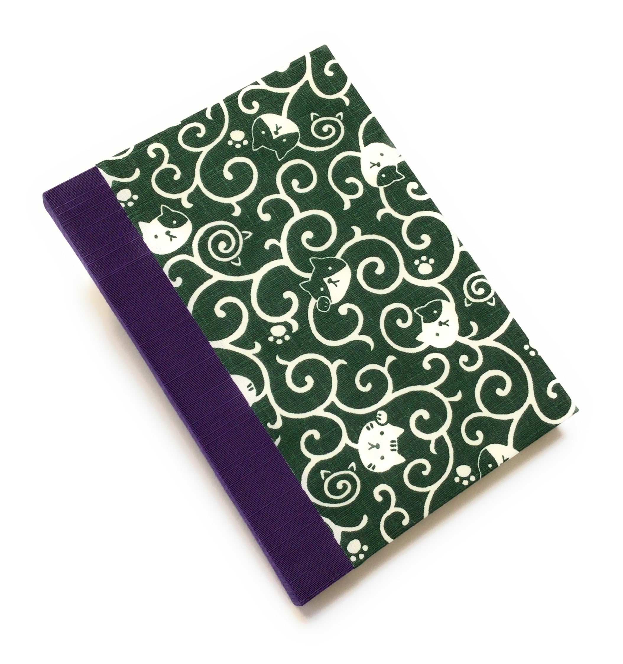 This handcrafted journal features a deep green fabric cover adorned with playful cat illustrations and swirling patterns. Bound with a purple bookbinding cloth, it is perfect for journaling, sketching, or note-taking, making it a great gift for cat lovers.