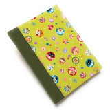 This handmade journal features a lively Japanese-inspired fabric cover adorned with lucky Daruma dolls, playful cat illustrations, and vibrant temari balls on a striking green background. The durable sage green spine adds contrast, making it a perfect notebook for journaling, sketching, or note-taking. Designed for cat lovers and fans of Japanese aesthetics, this unique handcrafted journal is a stylish and functional keepsake.