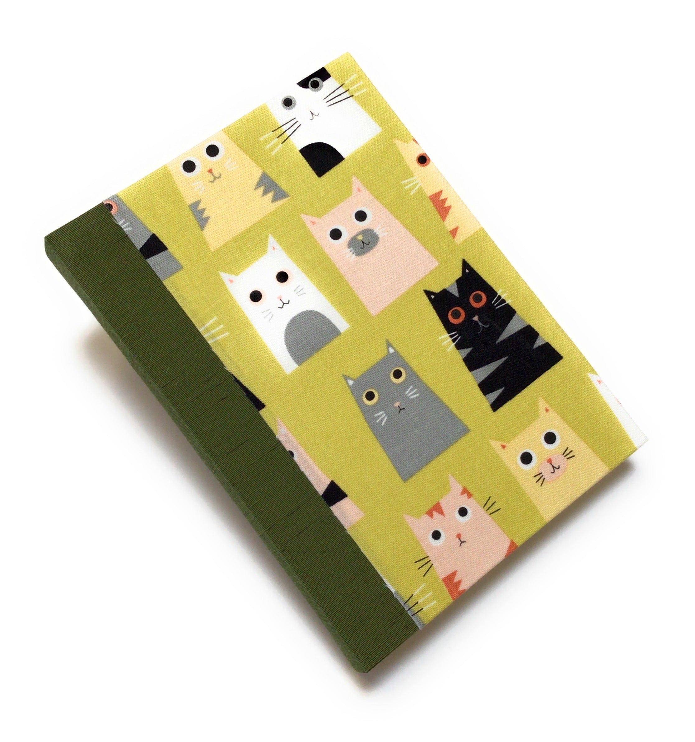 This handmade cat-themed journal features a whimsical fabric cover with a variety of charming cats on a vibrant yellow background. The durable bookbinding cloth spine adds strength, while the dotted interior pages provide ample space for journaling, sketching, or note-taking. Perfect for cat lovers, stationery enthusiasts, and those who appreciate unique handmade notebooks, this playful feline journal makes a great gift or personal keepsake.