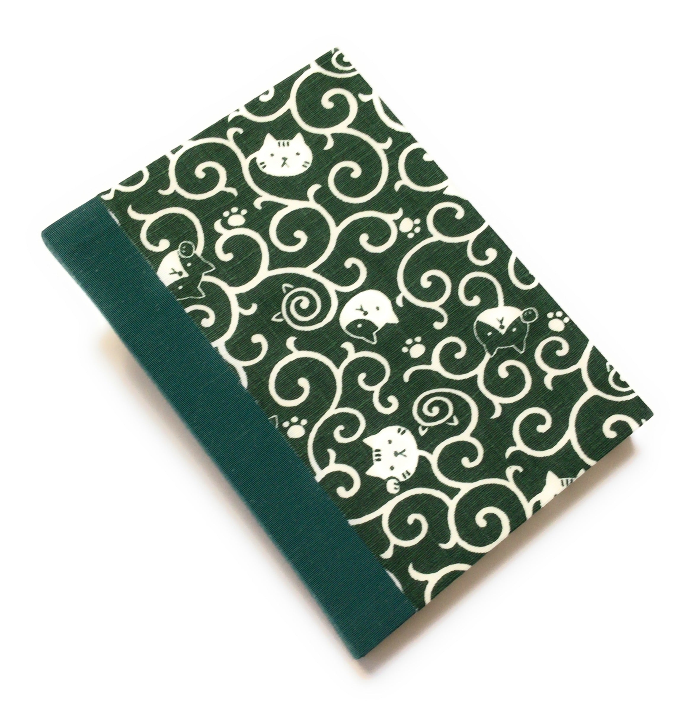 This handcrafted journal features a deep green fabric cover adorned with playful cat illustrations and swirling patterns. Bound with a matching green bookbinding cloth, it is perfect for journaling, sketching, or note-taking, making it a great gift for cat lovers.