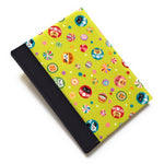 This handmade journal features a lively Japanese-inspired fabric cover adorned with lucky Daruma dolls, playful cat illustrations, and vibrant temari balls on a striking green background. The durable black spine adds contrast, making it a perfect notebook for journaling, sketching, or note-taking. Designed for cat lovers and fans of Japanese aesthetics, this unique handcrafted journal is a stylish and functional keepsake.