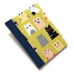 This handmade cat-themed journal features a whimsical fabric cover with a variety of charming cats on a vibrant yellow background. The dark blue bookbinding cloth spine adds strength, while the blank interior pages provide ample space for journaling, sketching, or note-taking. Perfect for cat lovers, stationery enthusiasts, and those who appreciate unique handmade notebooks, this playful feline journal makes a great gift or personal keepsake.