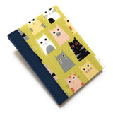 This handmade cat-themed journal features a whimsical fabric cover with a variety of charming cats on a vibrant yellow background. The dark blue bookbinding cloth spine adds strength, while the blank interior pages provide ample space for journaling, sketching, or note-taking. Perfect for cat lovers, stationery enthusiasts, and those who appreciate unique handmade notebooks, this playful feline journal makes a great gift or personal keepsake.