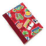 This handmade Aloha Journal features a vibrant red fabric cover decorated with playful Hawaiian-themed illustrations, including musubi, pineapples, beach slippers, and the classic "shaka" hand sign. The durable bookbinding cloth spine ensures longevity, while the blank interior pages provide the perfect space for journaling, sketching, or note-taking. A great choice for lovers of Hawaii-inspired stationery, unique handmade gifts, and island-themed journals.