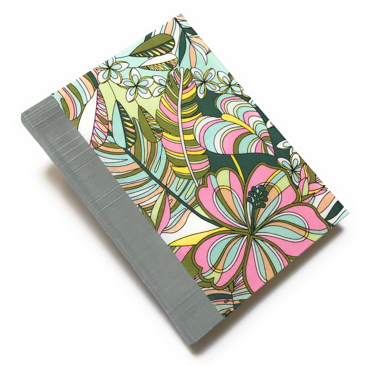 Pink, blue green, green, yellow, salmon colored, and white tropical flowers and leaves patterned journal with blue gray Japanese bookcloth spine. 220 blank pages. 5 x 7.