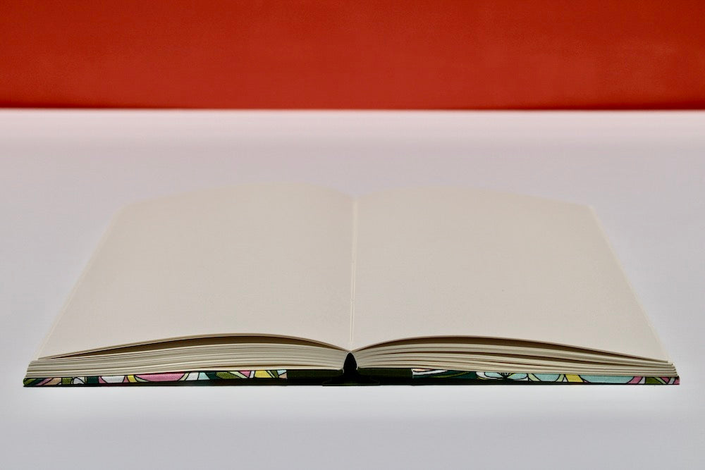 blank journal open flat with orange background