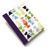 This handcrafted cat journal features a vibrant and playful fabric cover adorned with multicolor feline silhouettes, making it a perfect gift for cat lovers, writers, and artists. Bound with purple bookcloth and high-quality materials, this unique notebook is ideal for journaling, sketching, or note-taking.