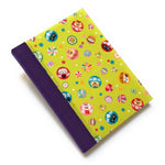 This handmade journal features a lively Japanese-inspired fabric cover adorned with lucky Daruma dolls, playful cat illustrations, and vibrant temari balls on a striking green background. The durable purple spine adds contrast, making it a perfect notebook for journaling, sketching, or note-taking. Designed for cat lovers and fans of Japanese aesthetics, this unique handcrafted journal is a stylish and functional keepsake.