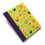 This handmade journal features a lively Japanese-inspired fabric cover adorned with lucky Daruma dolls, playful cat illustrations, and vibrant temari balls on a striking green background. The durable purple spine adds contrast, making it a perfect notebook for journaling, sketching, or note-taking. Designed for cat lovers and fans of Japanese aesthetics, this unique handcrafted journal is a stylish and functional keepsake.