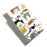 This handmade journal features a delightful fabric cover adorned with playful illustrated cats in various poses, making it a perfect notebook for cat lovers. Bound with a durable blue gray spine and filled with high-quality blank pages, it's an ideal choice for journaling, sketching, or note-taking with a touch of feline charm.